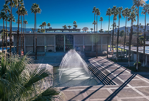 Photo of the College of the Desert Library building with the water fountain feature in the front